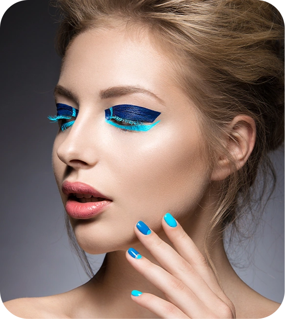 Beautiful girl with bright creative fashion makeup blue nail polish