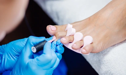 Home salon pedicure foot care treatment nail process professional pedicures master blue n gloves apply light pink gel polish